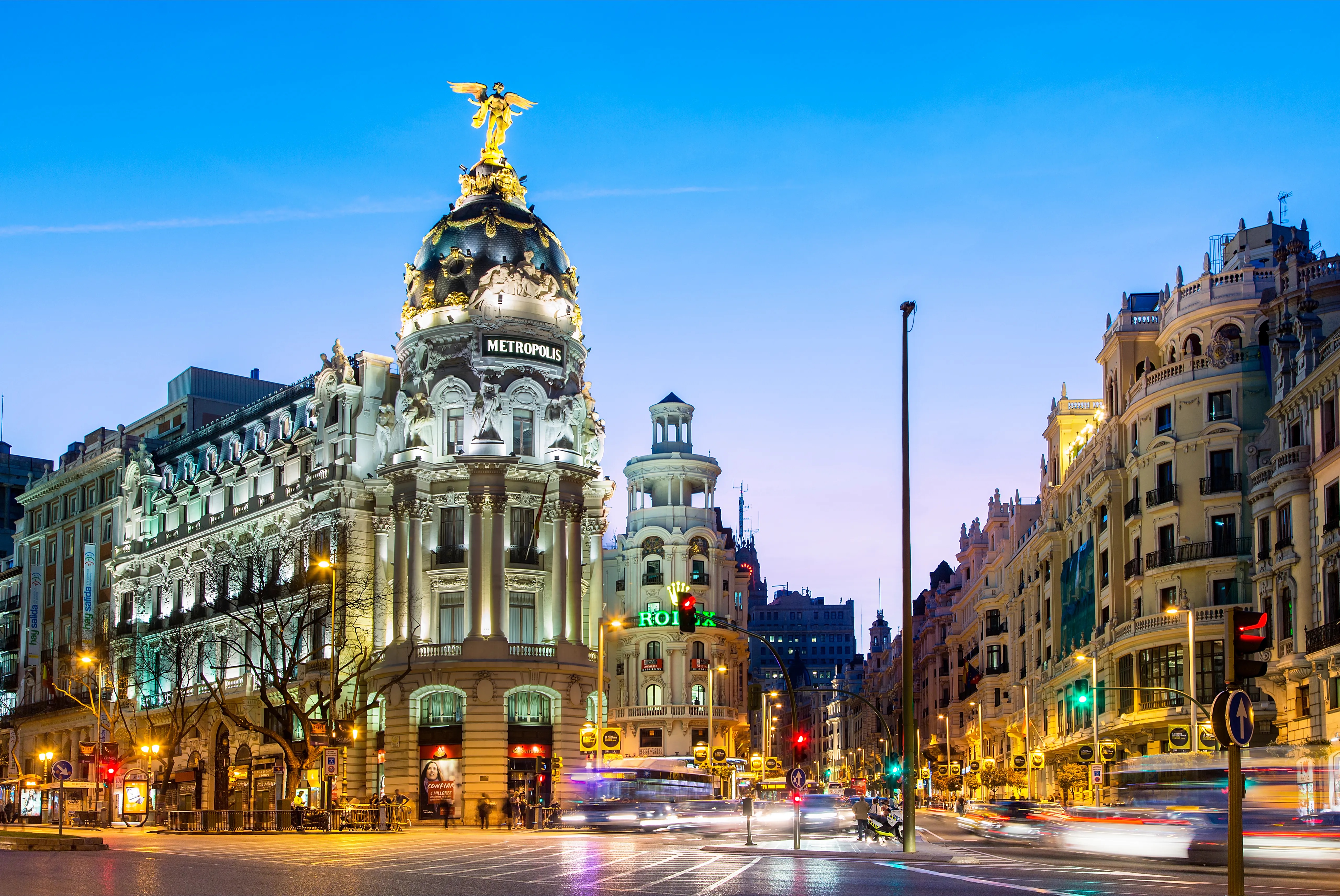 Photo of Madrid city street with people and buildings